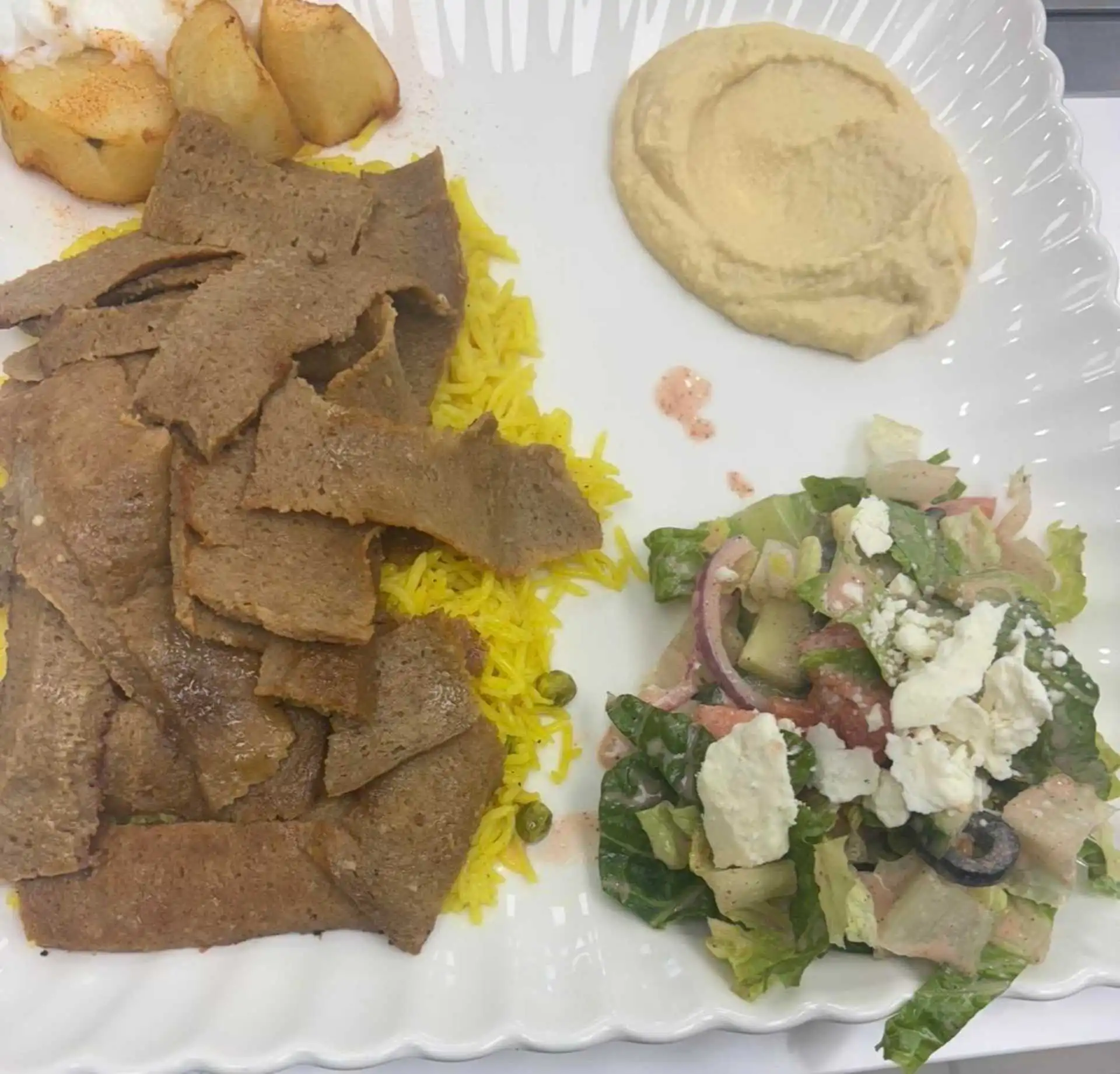 Beef Donair Plate with rice and traditional sides at Shawarmero Lebanese Grill