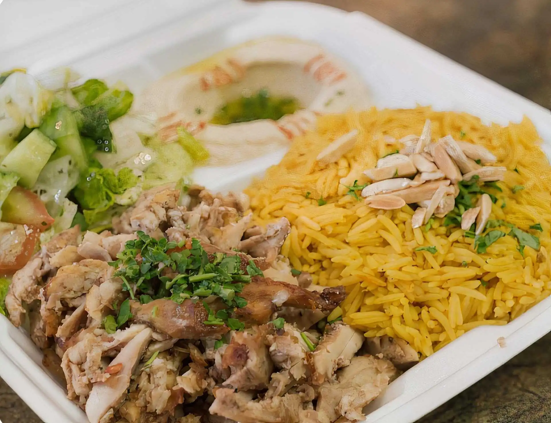 Chicken Shawarma Plate with rice, salad, and hummus at Shawarmero Lebanese Grill