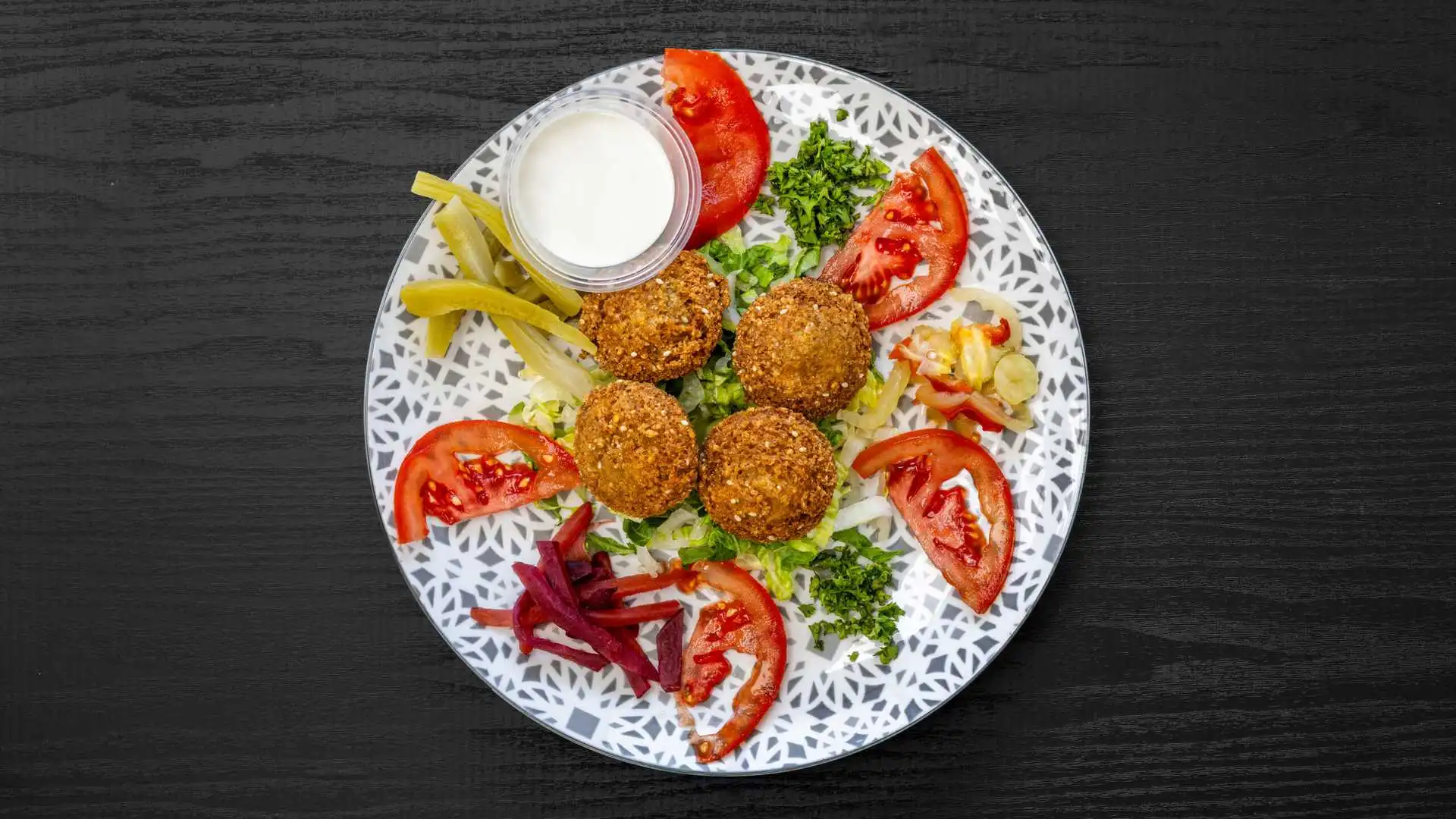 Falafel Plate with pita, hummus, and salad at Shawarmero Lebanese Grill